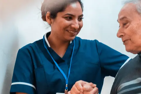 A carer supporting an older person at home