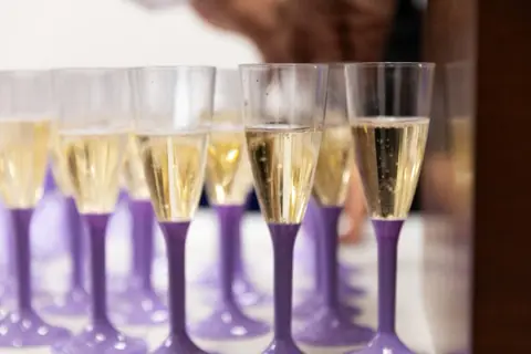Glasses being filled at a hospitality event