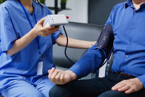 A nurse taking a patient’s blood pressure
