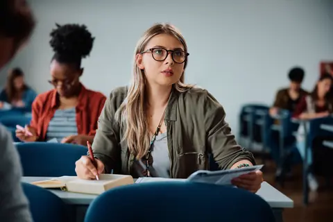 A student writing notes during an assessment
