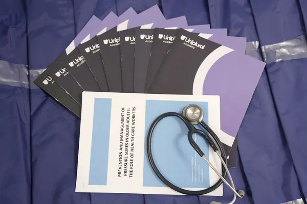 Uniplural Academy graduation folder with a stethoscope