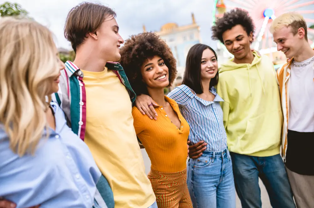 A group of smiling young students standing together outdoors
